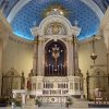 The sanctuary of the Immaculate Conception Cathedral has a large sky blue dome on top and a single-shelf white reredos that contains a crucifix enclosed in a brown semi-oblong frame, six candles in front of the crucifix, and the tabernacle just below the crucifix. The reredos is flanked by two steel gates. The altar in front of the reredos is also white and draped with white cloth and a sun-like embossed decoration in front. The lectern on the left is also white with embossed decoration of four persons. The priest's chair is on the right. On the left of the lectern is the cathedra or bishop's throne; it is navy blue with goldtone highlights. It has a roof-like dome on top, main chair, two side chairs, and a podium in front of the main chair.